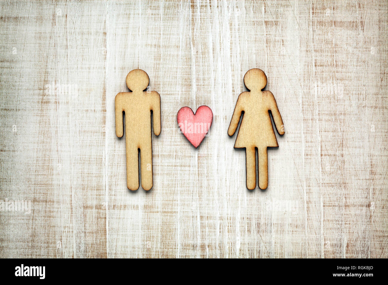 Man and woman shape with heart  on wooden background Stock Photo