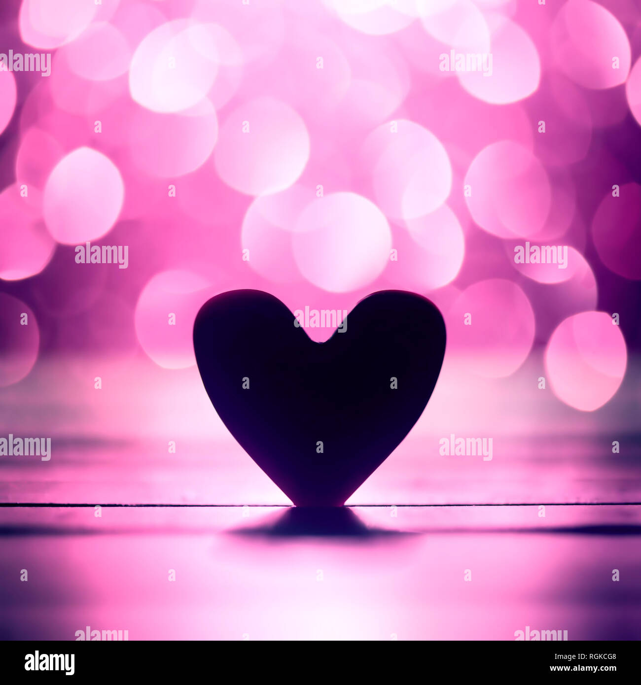 Single heart and pink bokeh abstract background Stock Photo