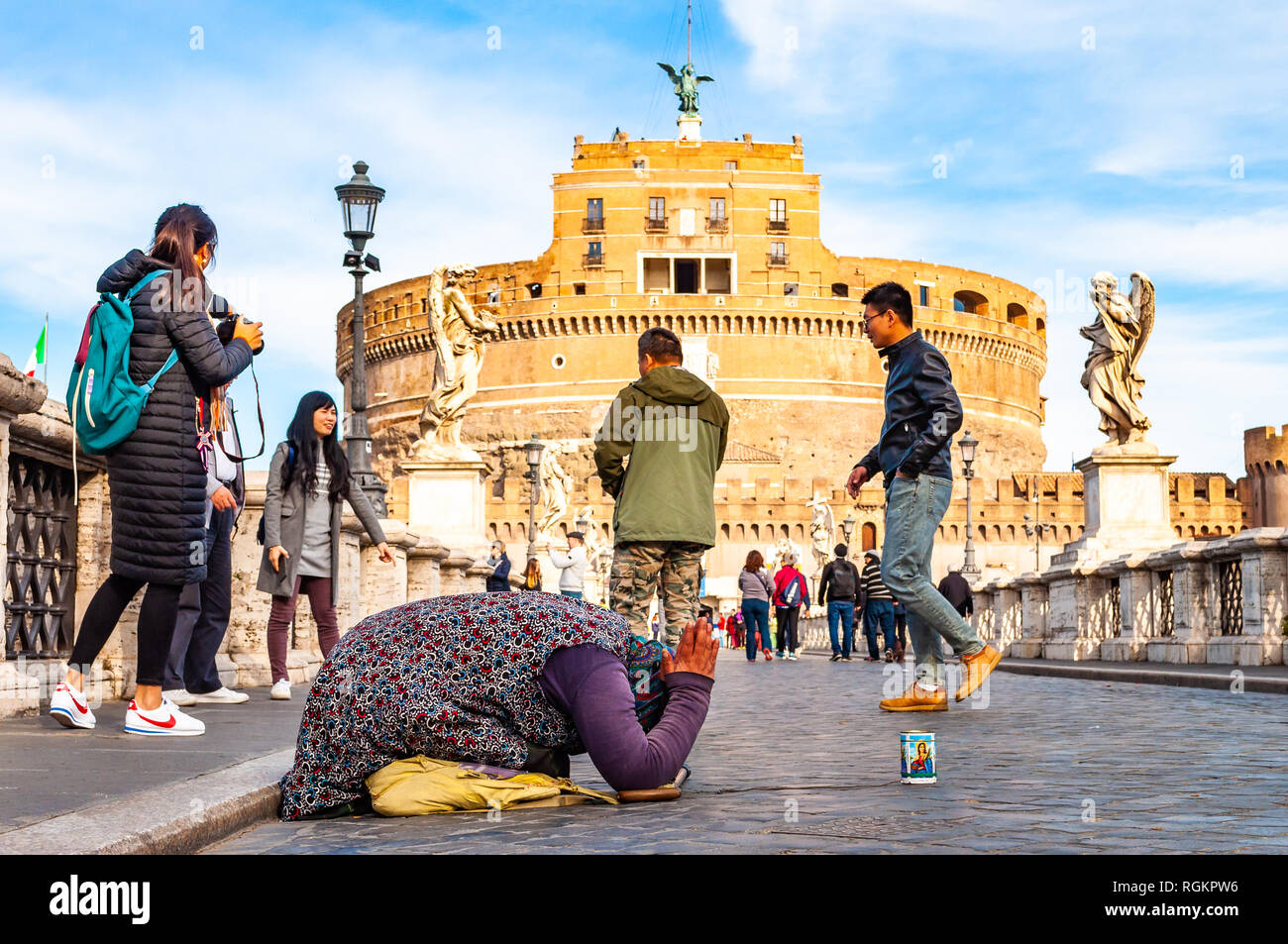 Rome, Italy - November 17, 2018: Beggar woman asking alms on her knees ...