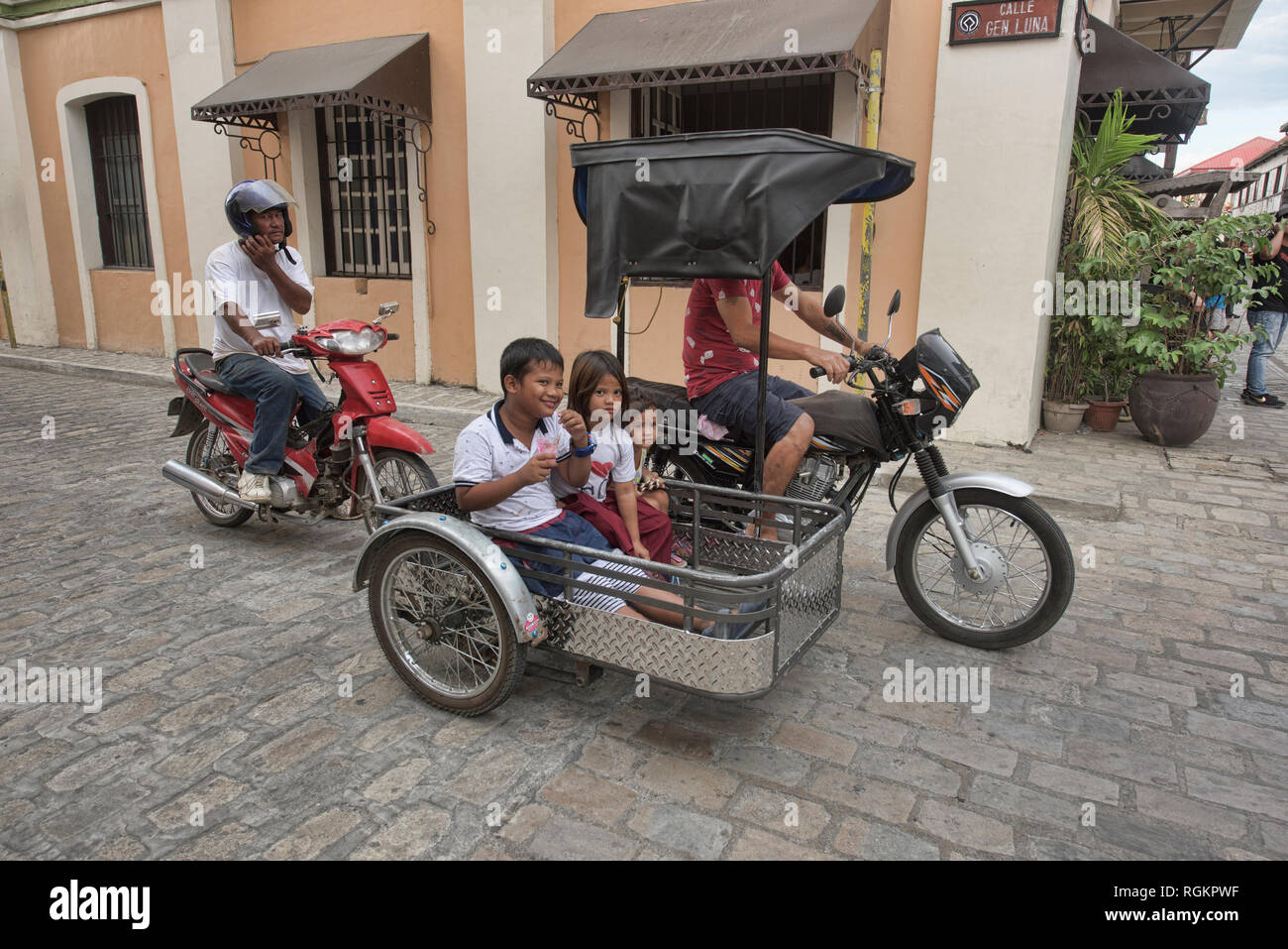 Kids using tricycle transport, Vigan, Ilocos Sur, Philippines Stock Photo