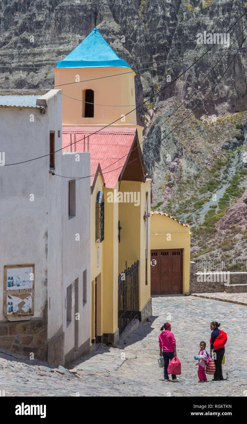 People in front of the colorful church of Iruya, Argentina Stock Photo