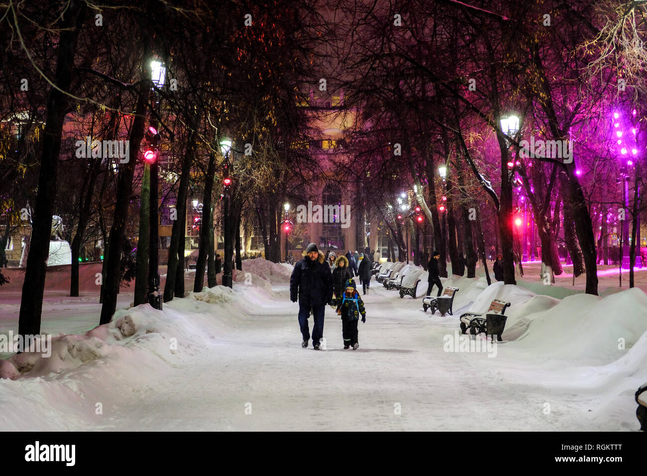 People walking under the trees in the park of Chistye Prudy during ...