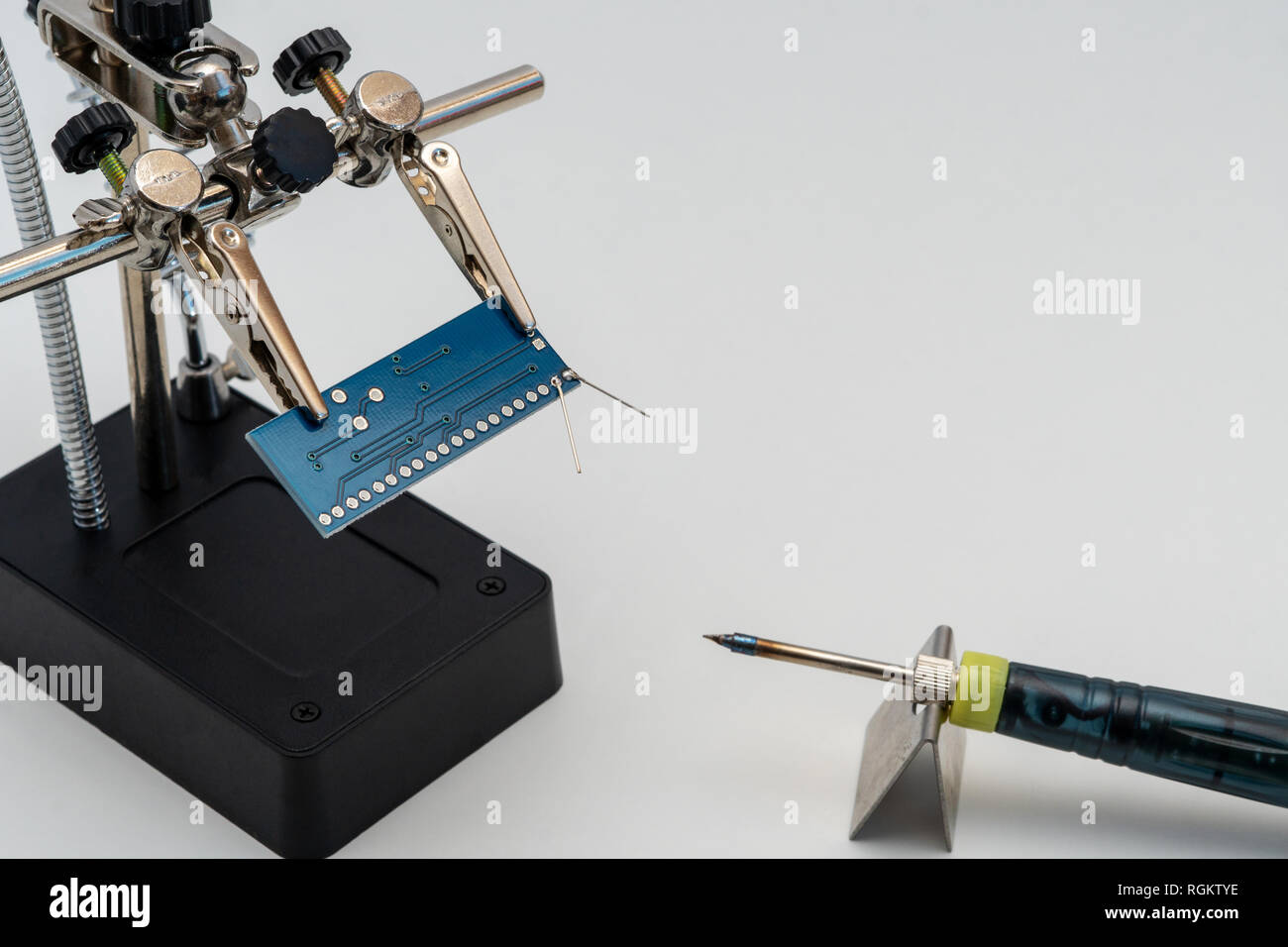 Circuit board in soldering helping hands (third hand or auxiliary clip