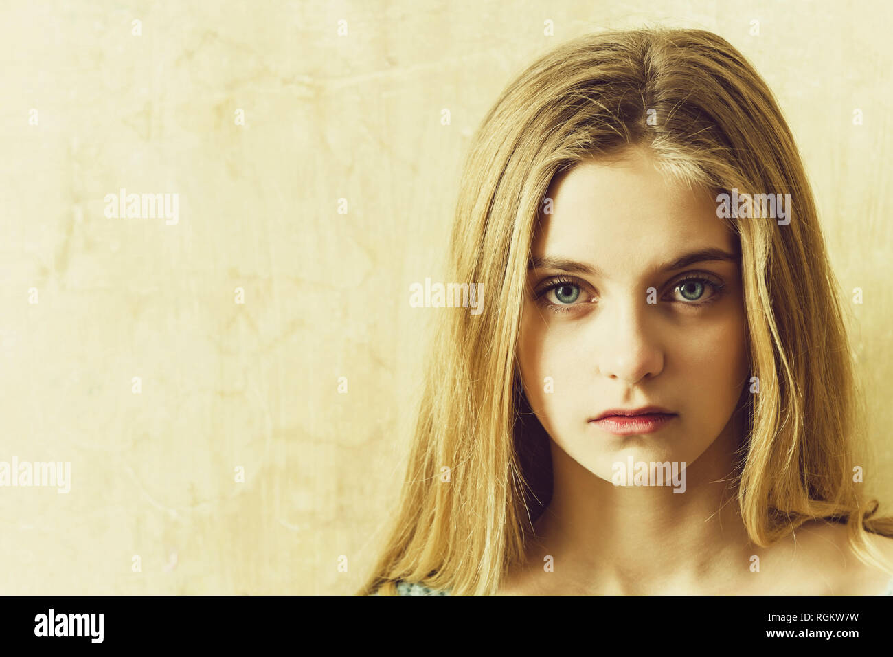 Pretty Young Girl With Blond Hair And Big Blue Eyes Stock Photo