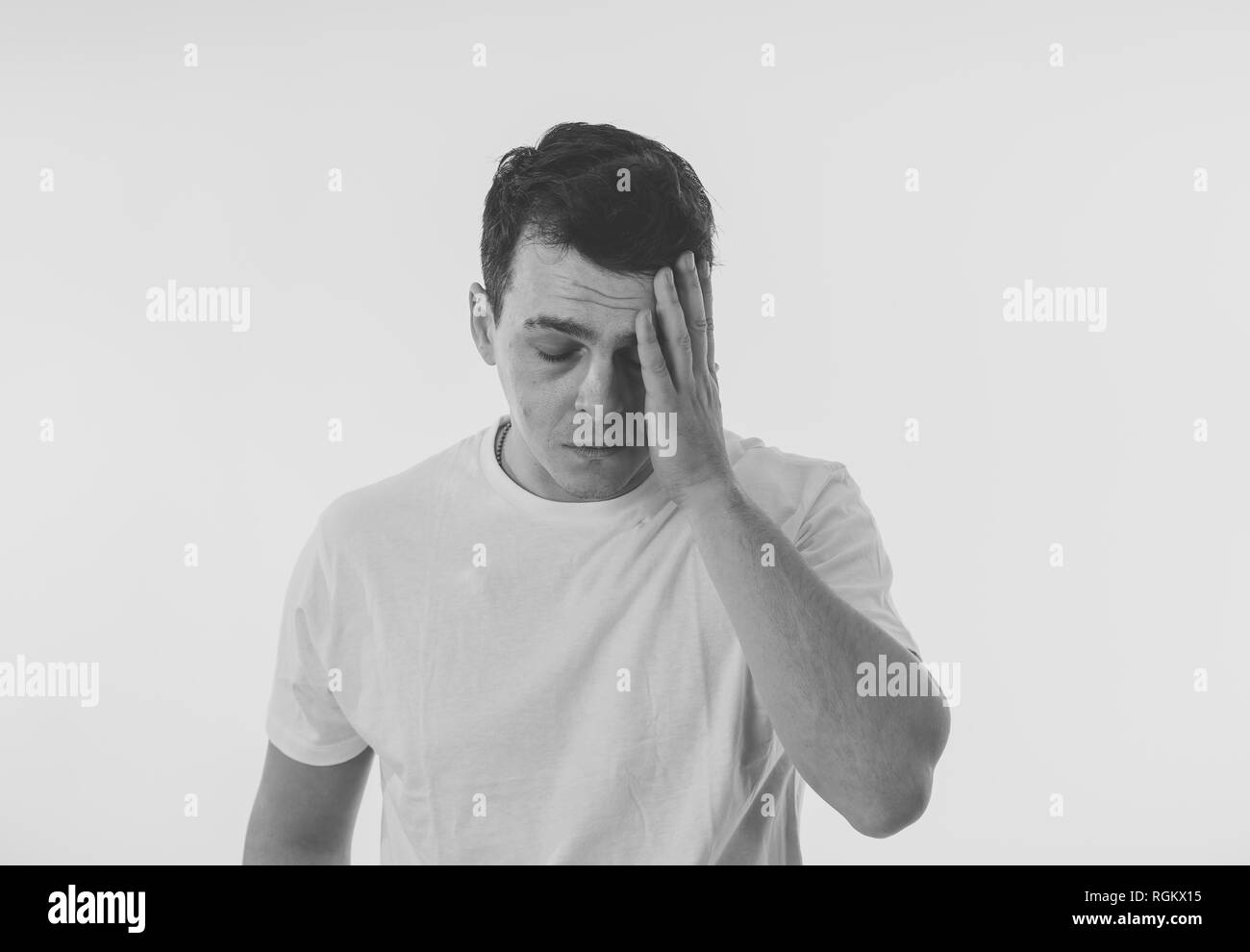 Close up portrait of attractive sad depressed man suffering depression feeling sorrow and emotional pain in people, human emotions face expressions an Stock Photo