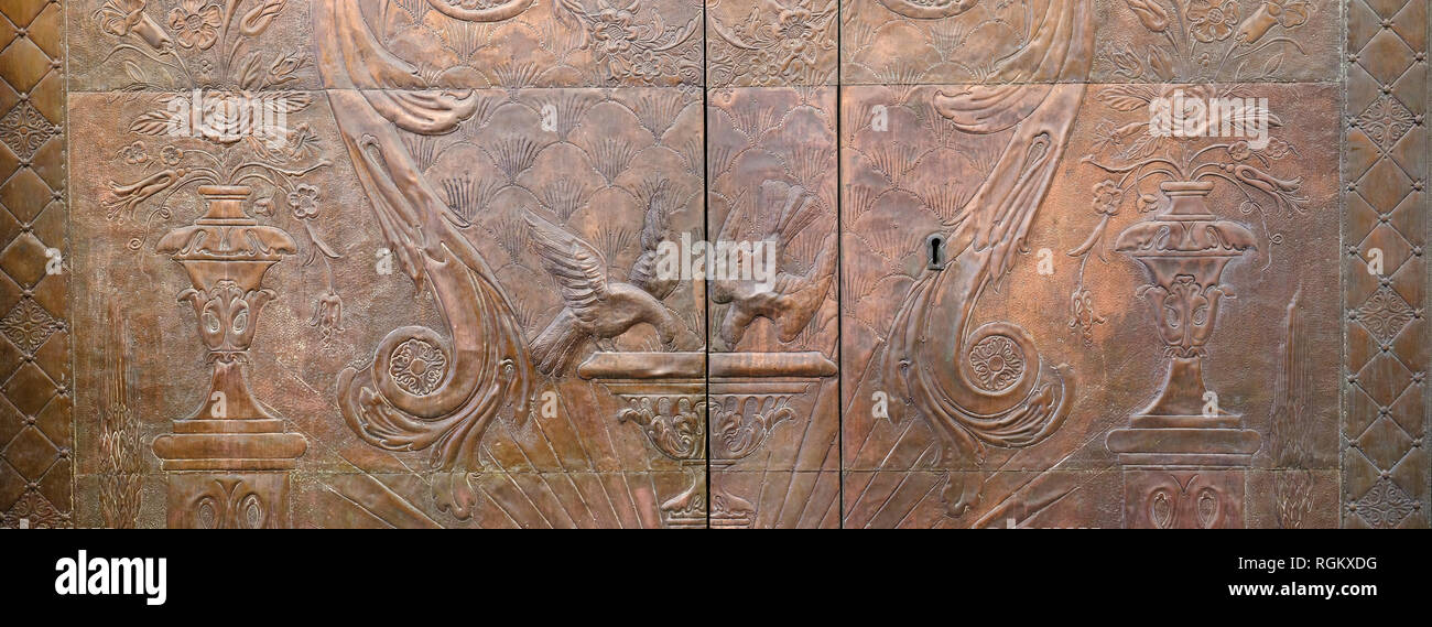 Decorative Ornate Metal Engraved Picture Door Depicting Birds Urns and Garden Scene Seville Spain Stock Photo