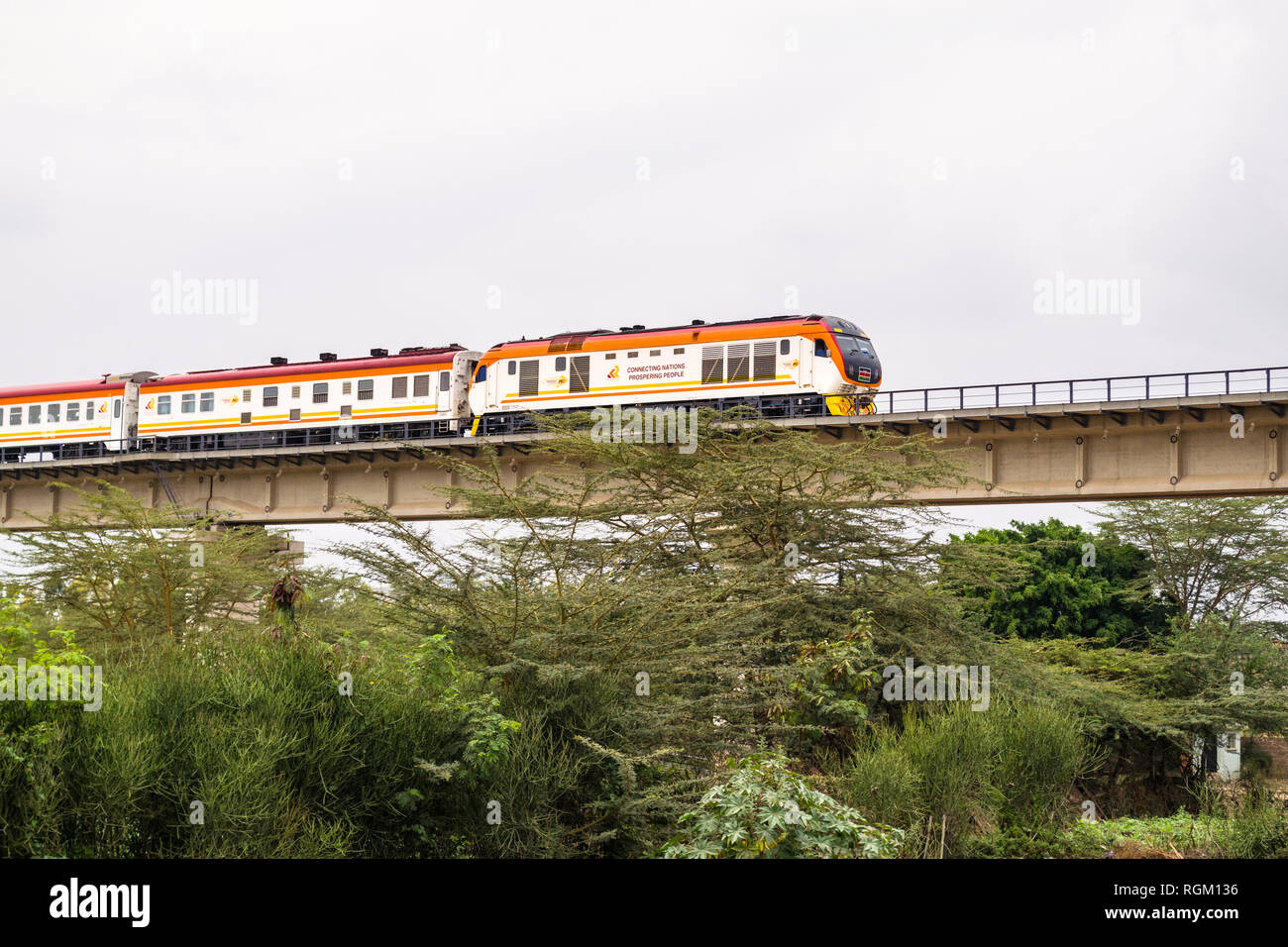 The Madaraka Express Passenger Service train travelling on a viaduct section of the Nairobi to Mombasa Standard Gauge Railway SGR, Athi River, Kenya Stock Photo