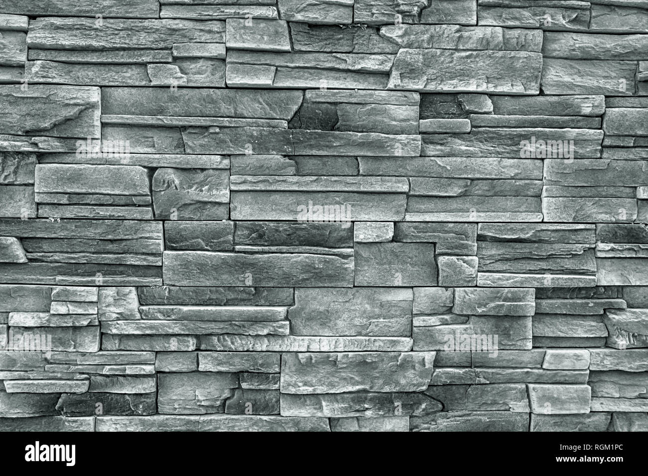 Close up granite texture brick wall. Pattern of grey texture. Decorative slate stone wall