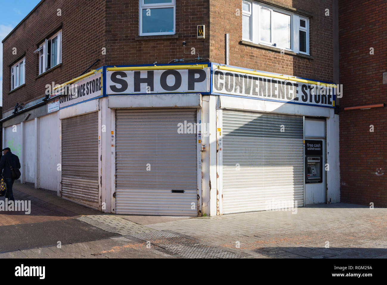 Shutters closed down on a convenience store in West Bromwich High Street, West Midlands Stock Photo