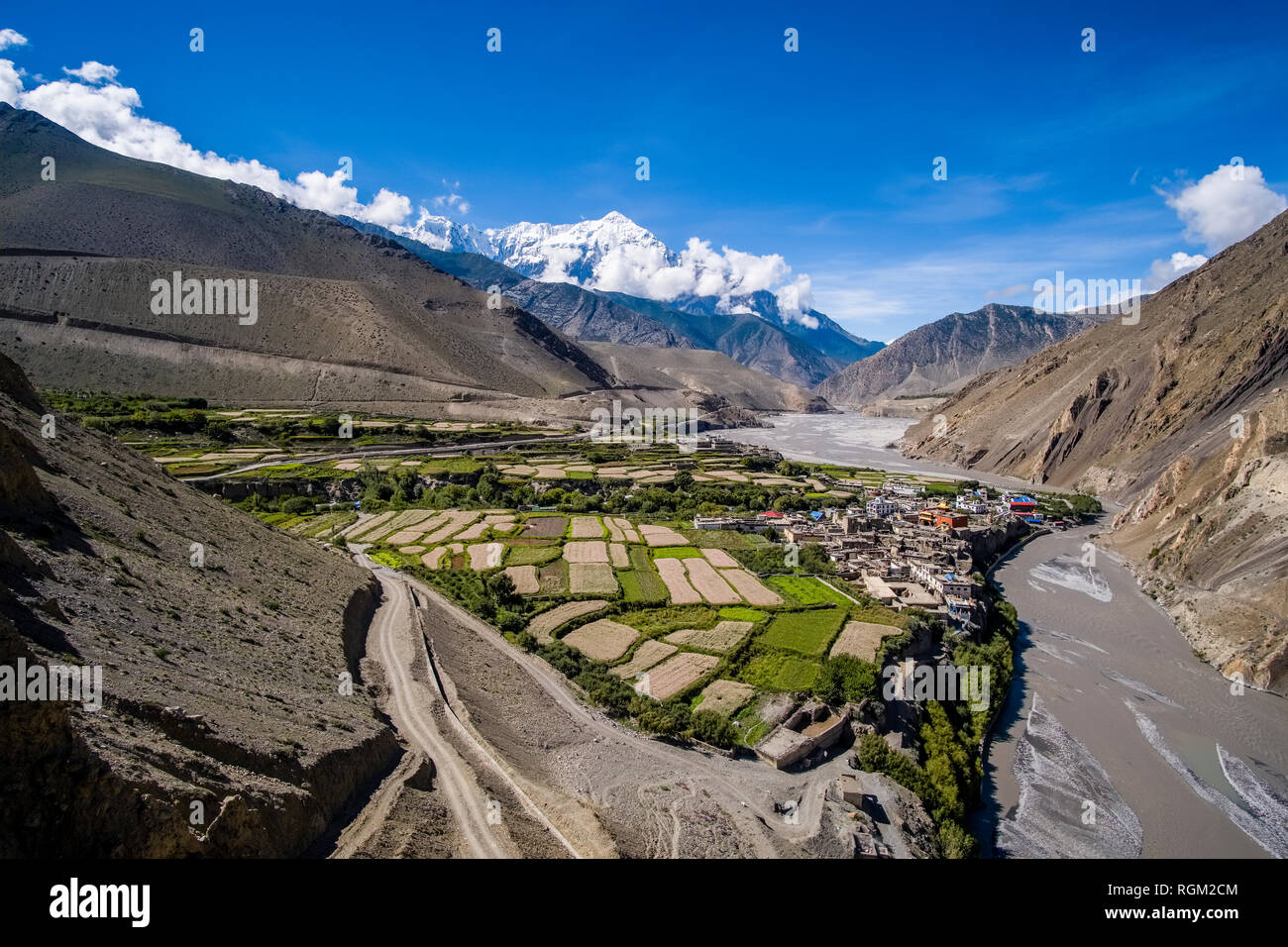 Aerial view on the town and agricultural surroundings in Kali Gandaki valley, the summit of the mountain Nilgiri in the distance Stock Photo