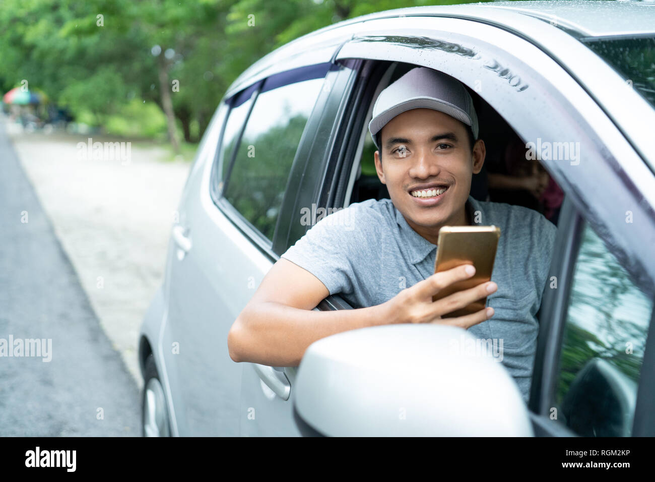 Young asian man driving a car hi-res stock photography and images - Alamy