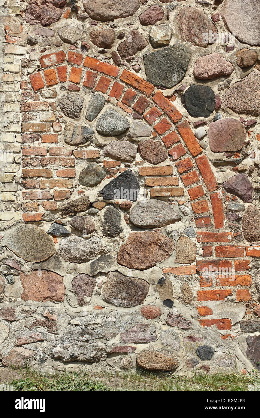 Bricked up pointed arch portal of a medieval village church Stock Photo