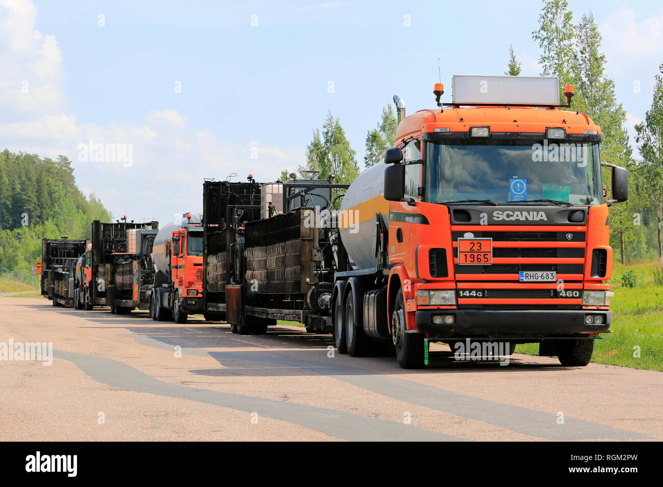 Kaarina, Finland - July 28, 2018: Roadworks asphalting machinery transport trucks parked on a freeway rest stop in summer in South of Finland. Stock Photo
