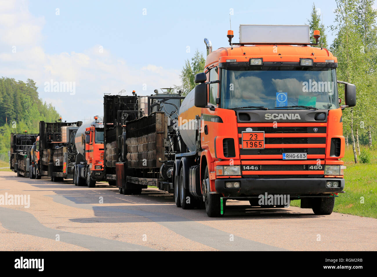 Kaarina, Finland - July 28, 2018: Roadworks asphalting machinery transport trucks parked on a freeway rest stop in summer in South of Finland. Stock Photo
