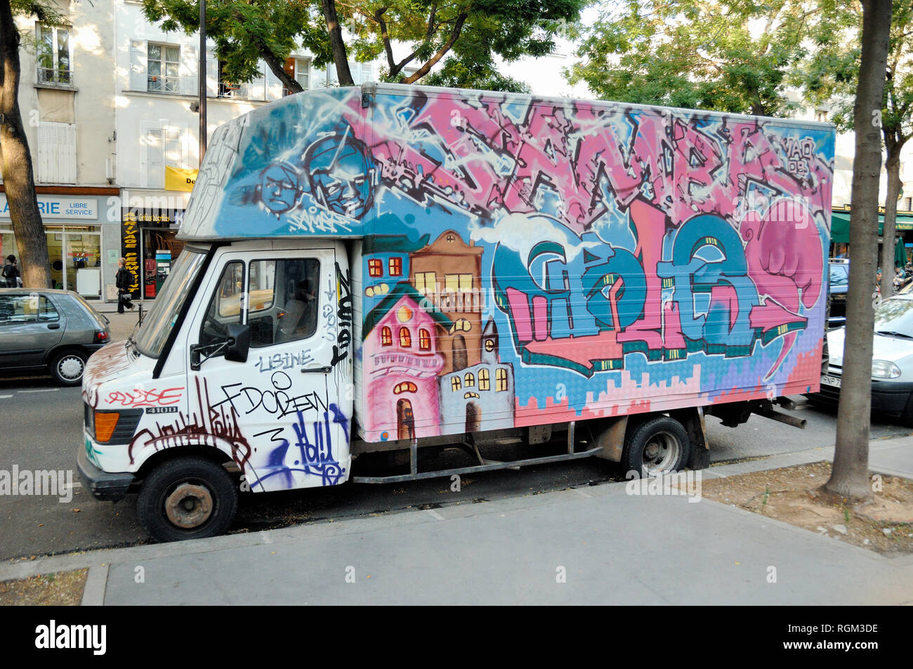 Graffiti-Covered White Van Parked in Street Paris France Stock Photo