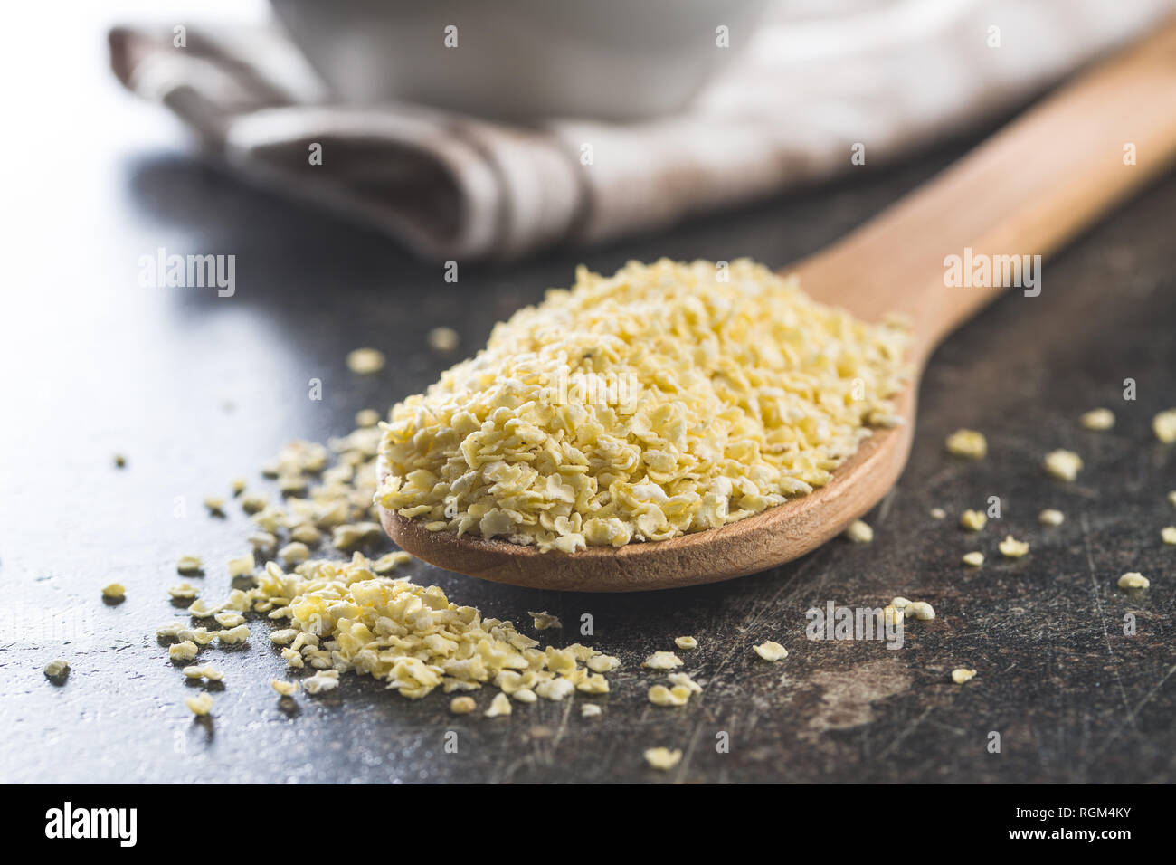 Healthy millet flakes in wooden spoon Stock Photo Alamy