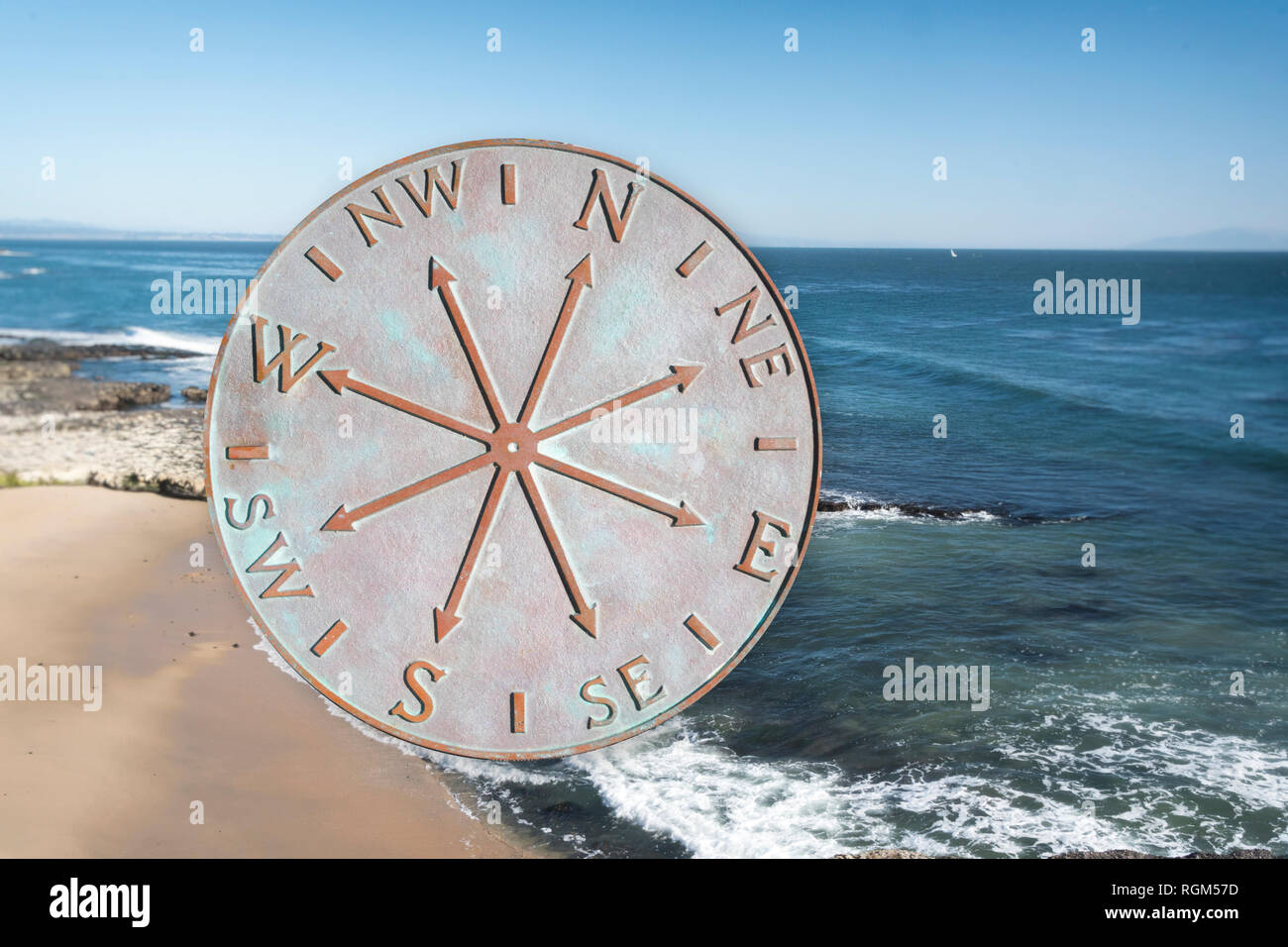Old metal comopass isolated on ocean background Stock Photo