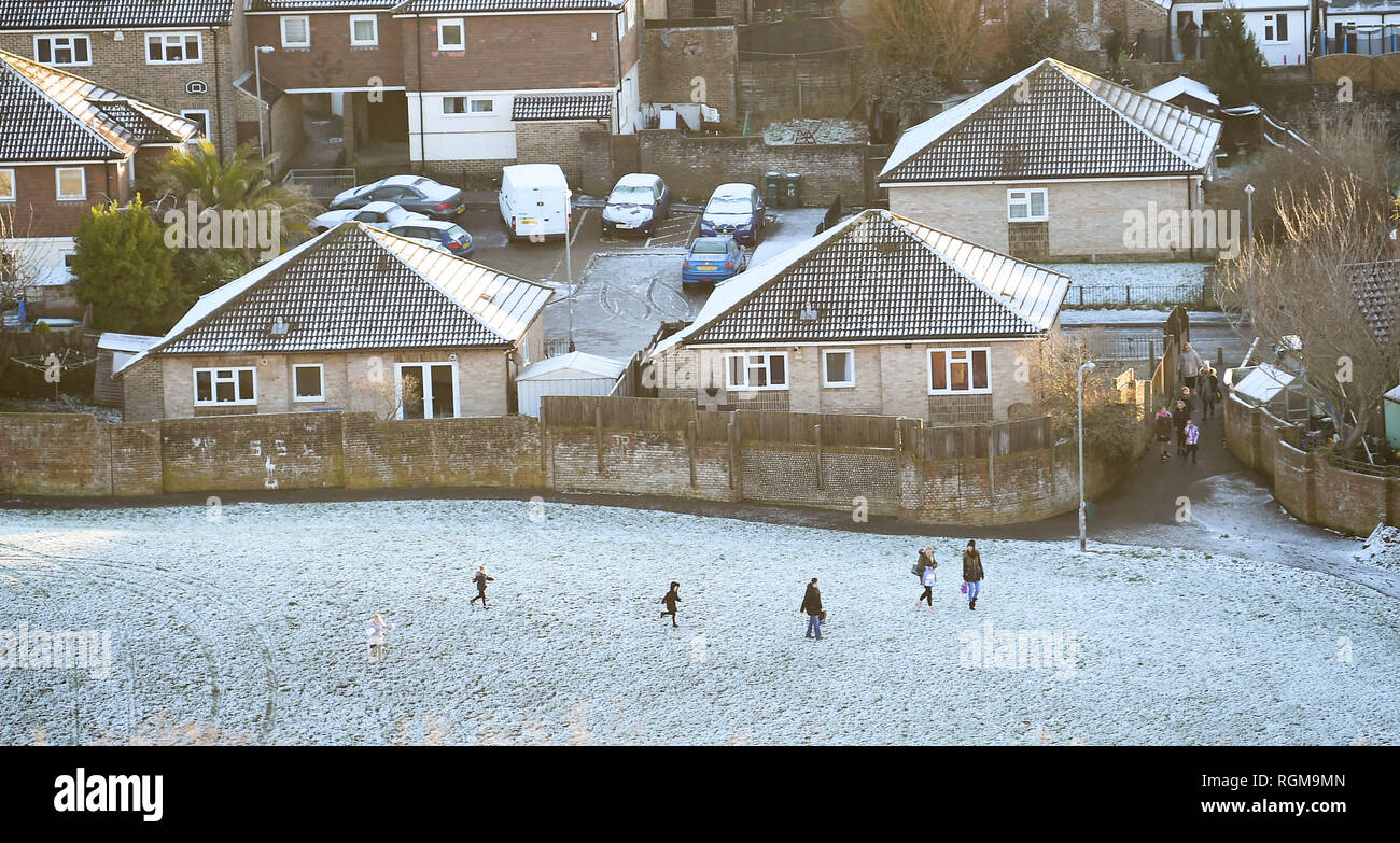 Brighton UK 30th January 2019 - Families play in the snow on the Whitehawk housing estate in Brighton today as more snow and freezing conditions are forecast for the south east of Britain tomorrow Credit: Simon Dack/Alamy Live News Stock Photo