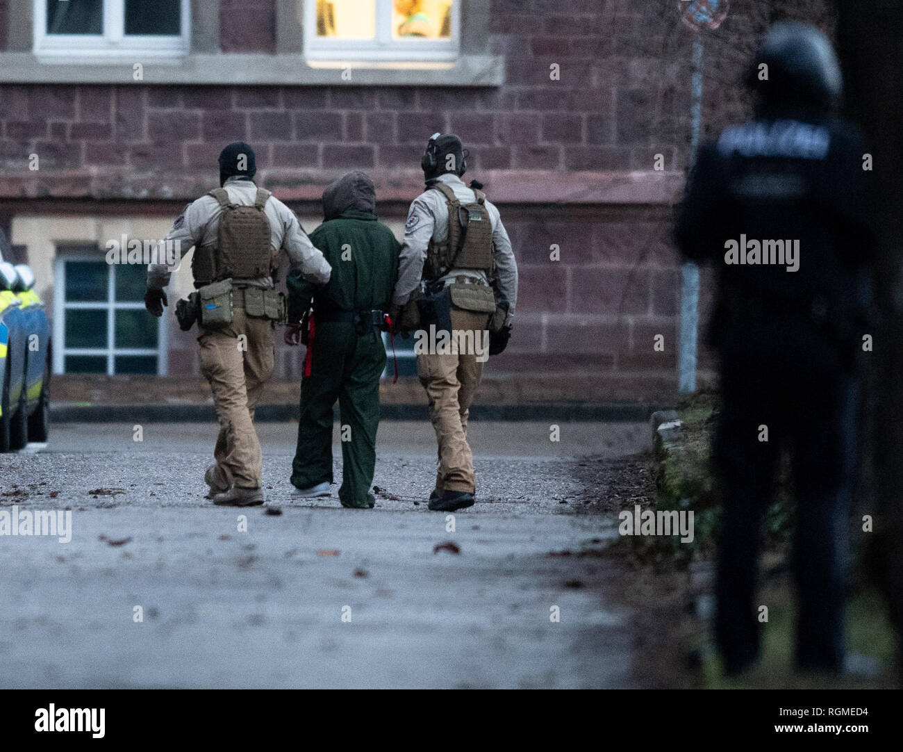 Karlsruhe, Germany. 30th Jan, 2019. Federal police officers are taking a  suspected terrorist away. On Wednesday morning, officers of the Federal  Criminal Police Office arrested three men from Iraq in the district