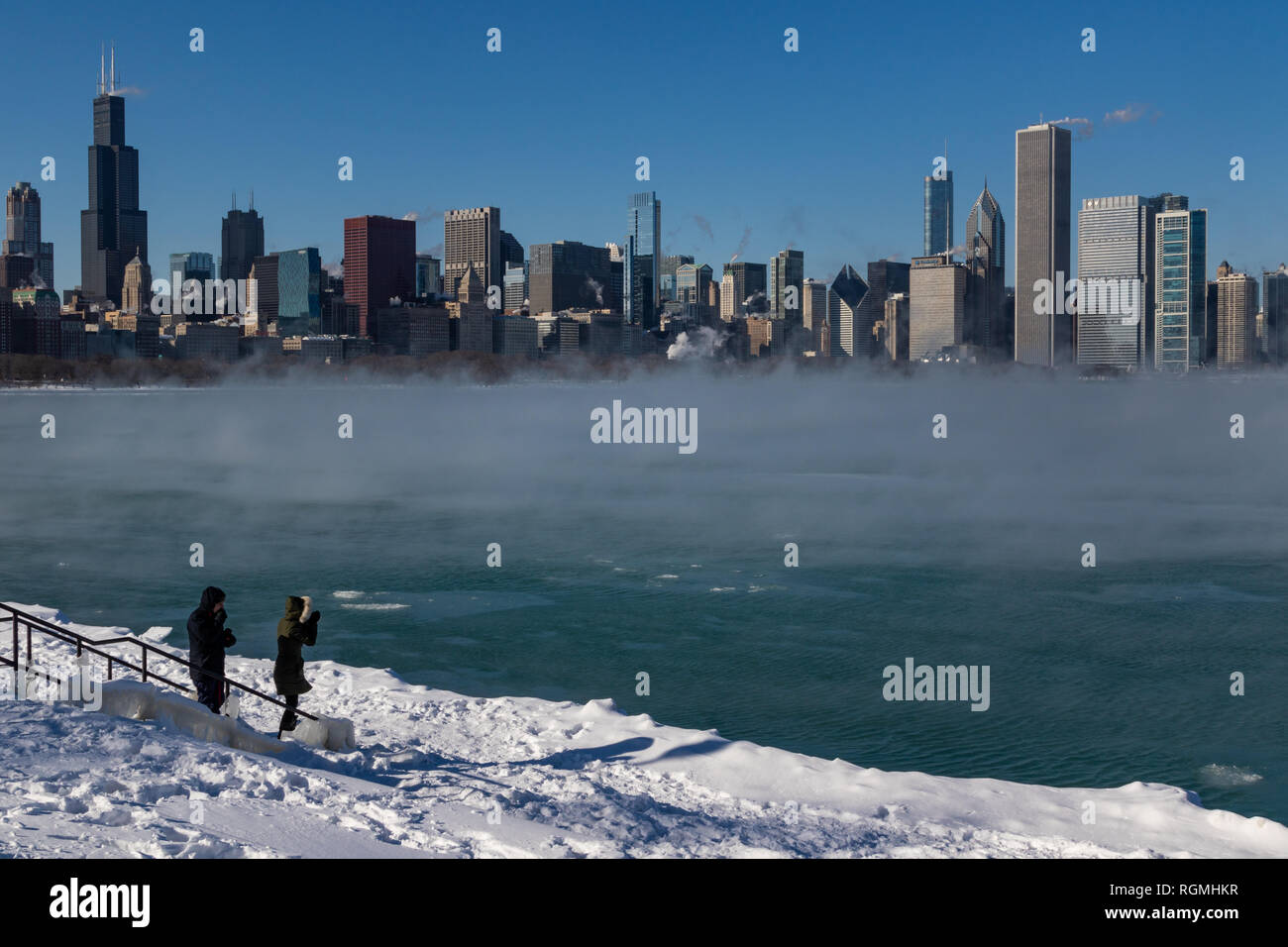Chicago, USA. 30th Jan 2019. Despite the polar vortex and temperatures of 20 below zero some hardy folks ventured to Chicago's shoreline to see the unusual winter fog effect rising from the not yet frozen Lake Michigan Credit: Matthew Kaplan/Alamy Live News Stock Photo
