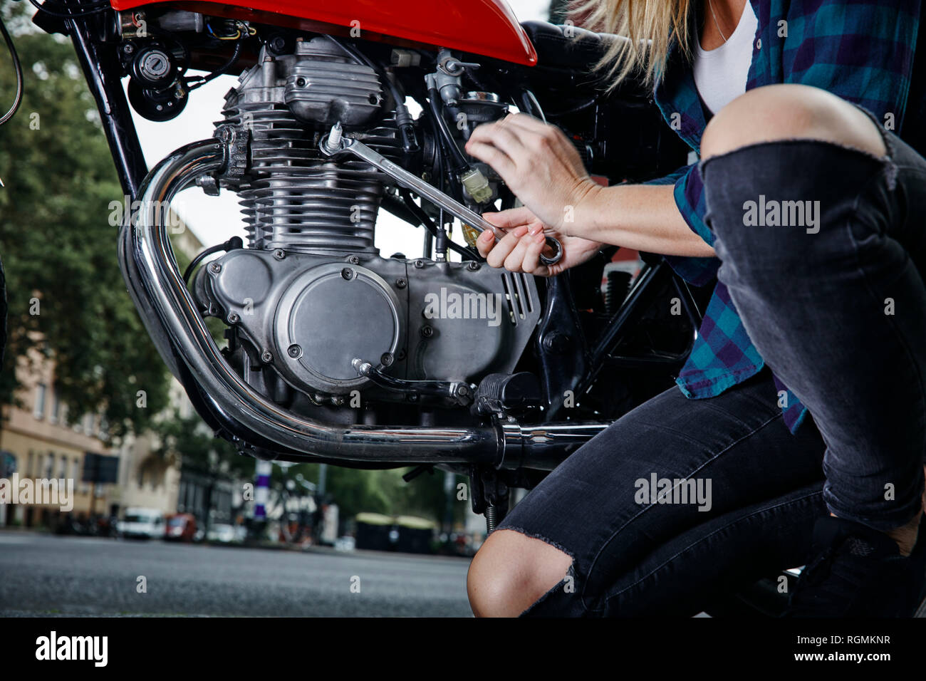 Young woman working on motorcycle Stock Photo Alamy