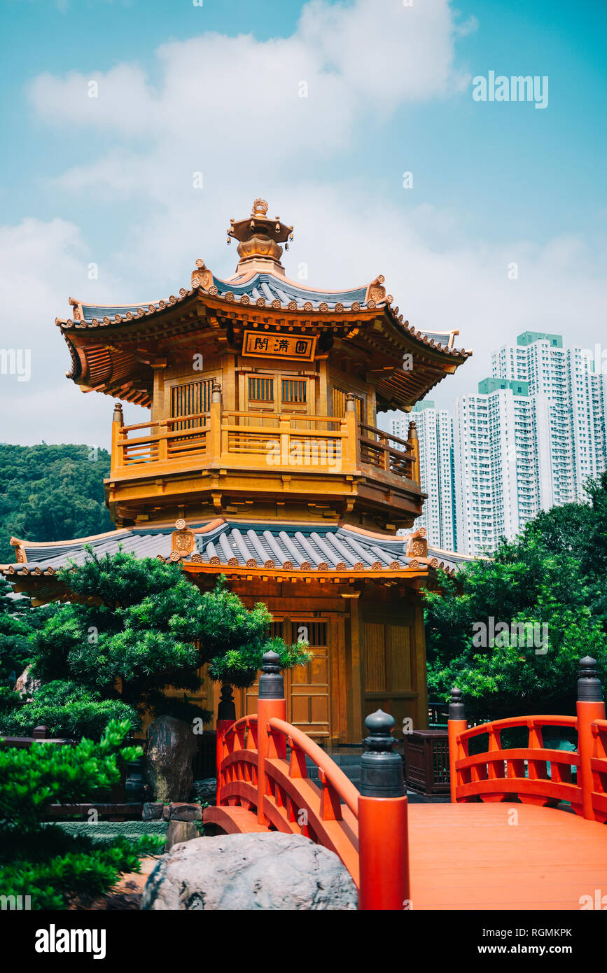 China, Hong Kong, Nan Lian Garden, Golden Pavilion of Absolute Perfection surrounded by skyscrapers Stock Photo