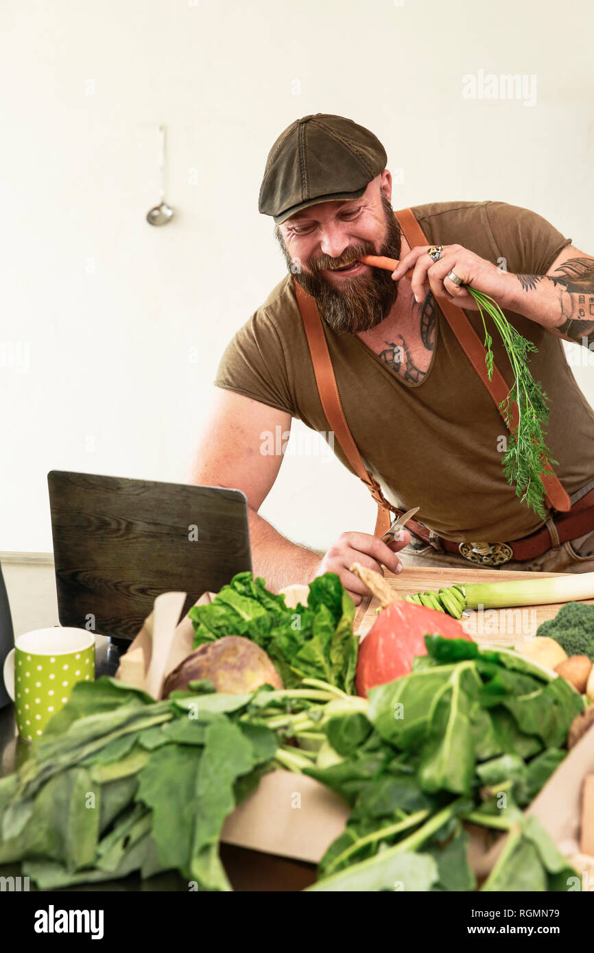 Mature man trying out vegetarian online-recipes Stock Photo