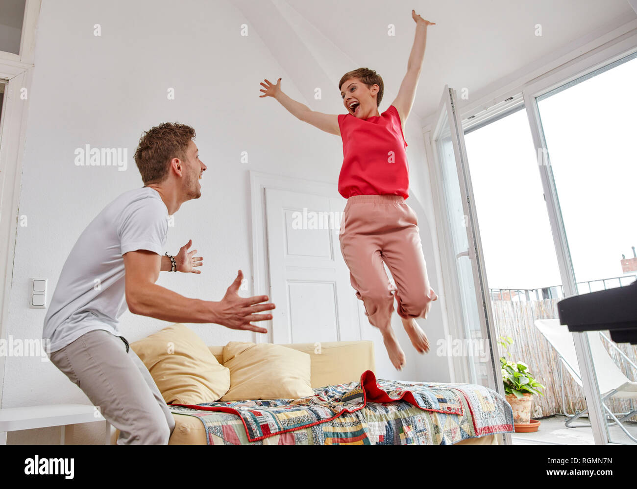 Excited couple in living room at home Stock Photo