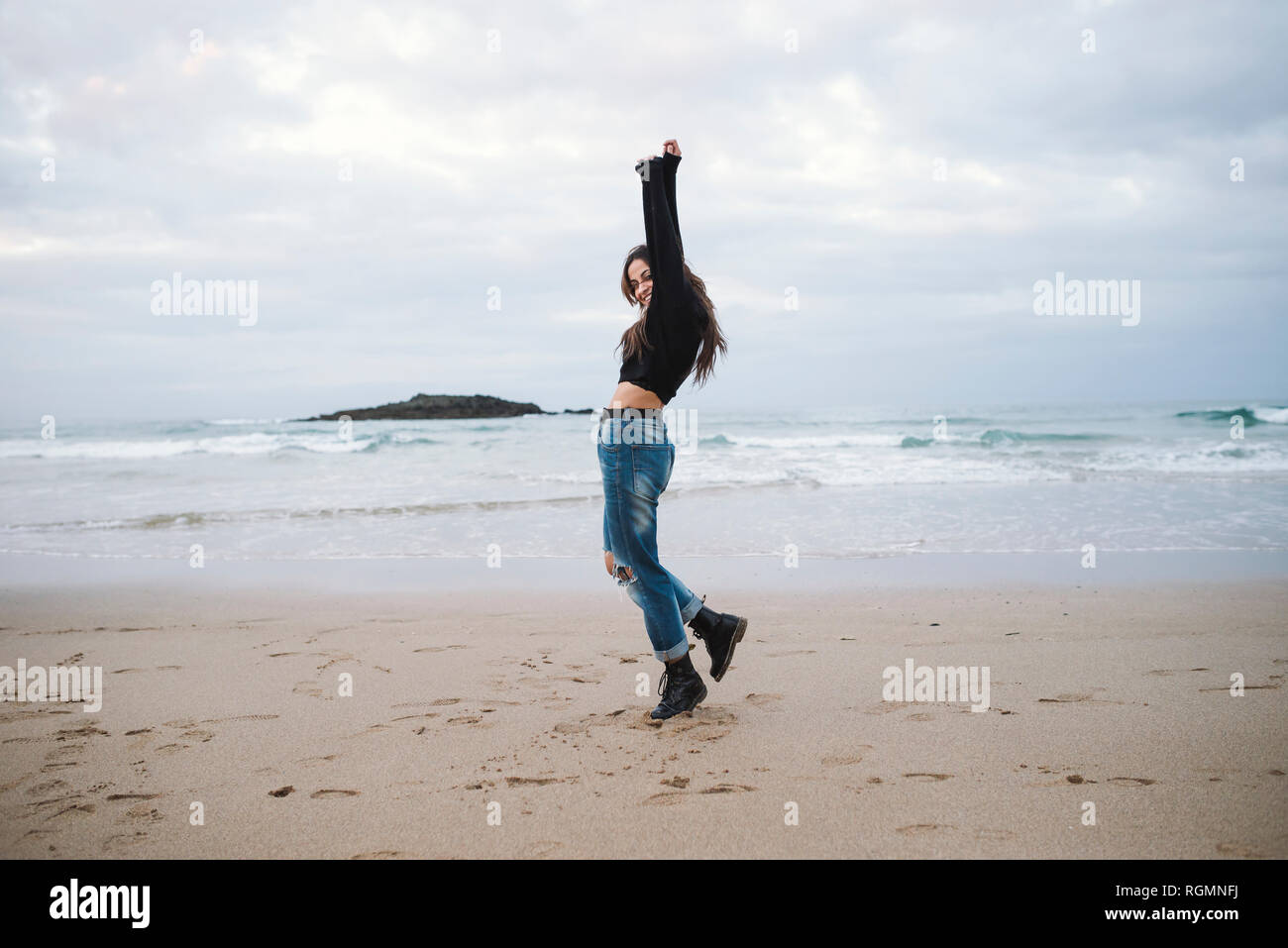 Spain, happy young woman on the beach Stock Photo