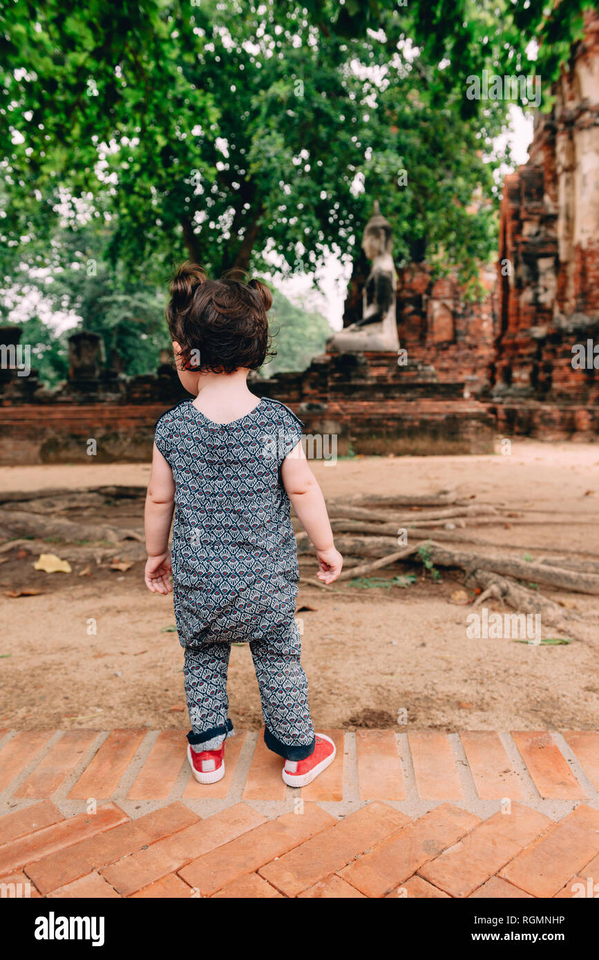 Thailand, Ayutthaya, Baby girl exploring Wat Mahathat temple Stock Photo