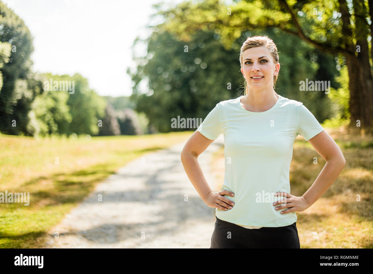 Young woman in park standing hi-res stock photography and images - Alamy