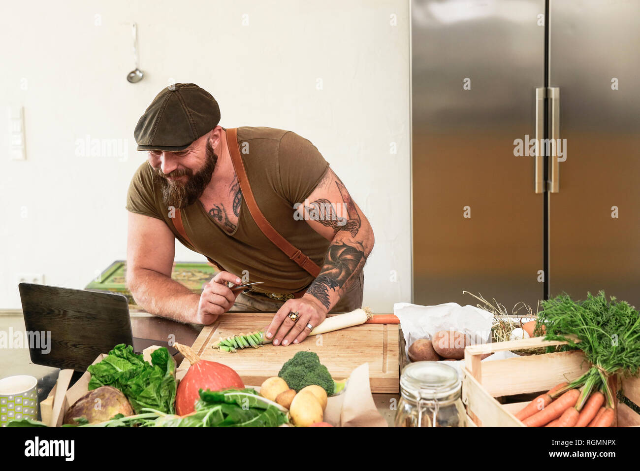 Mature man trying out vegetarian online-recipes Stock Photo