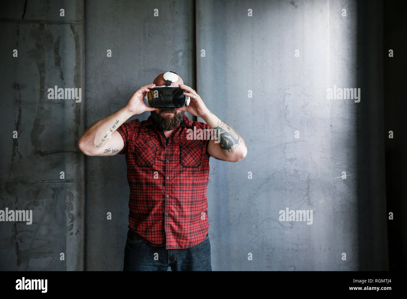 Bearded man wearing VR glasses Stock Photo