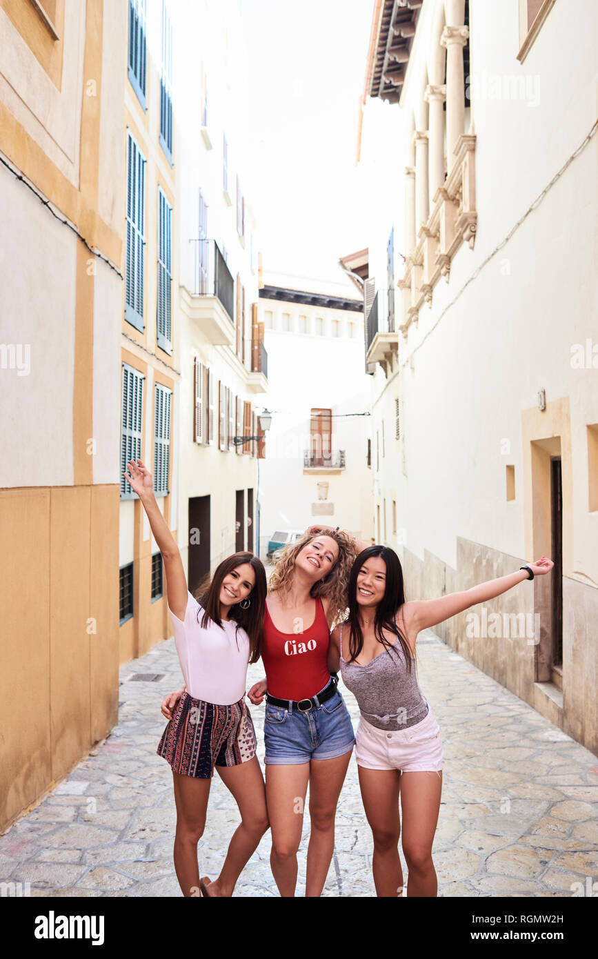 Spain, Mallorca, Palma, portrait of three happy young women in the city Stock Photo