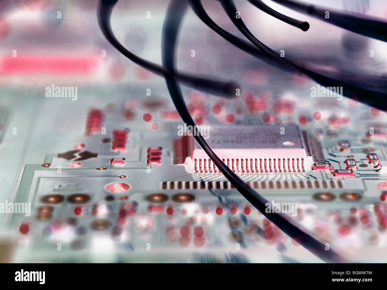 Fibre optics attacking electronic circuit boards with a virus Stock Photo
