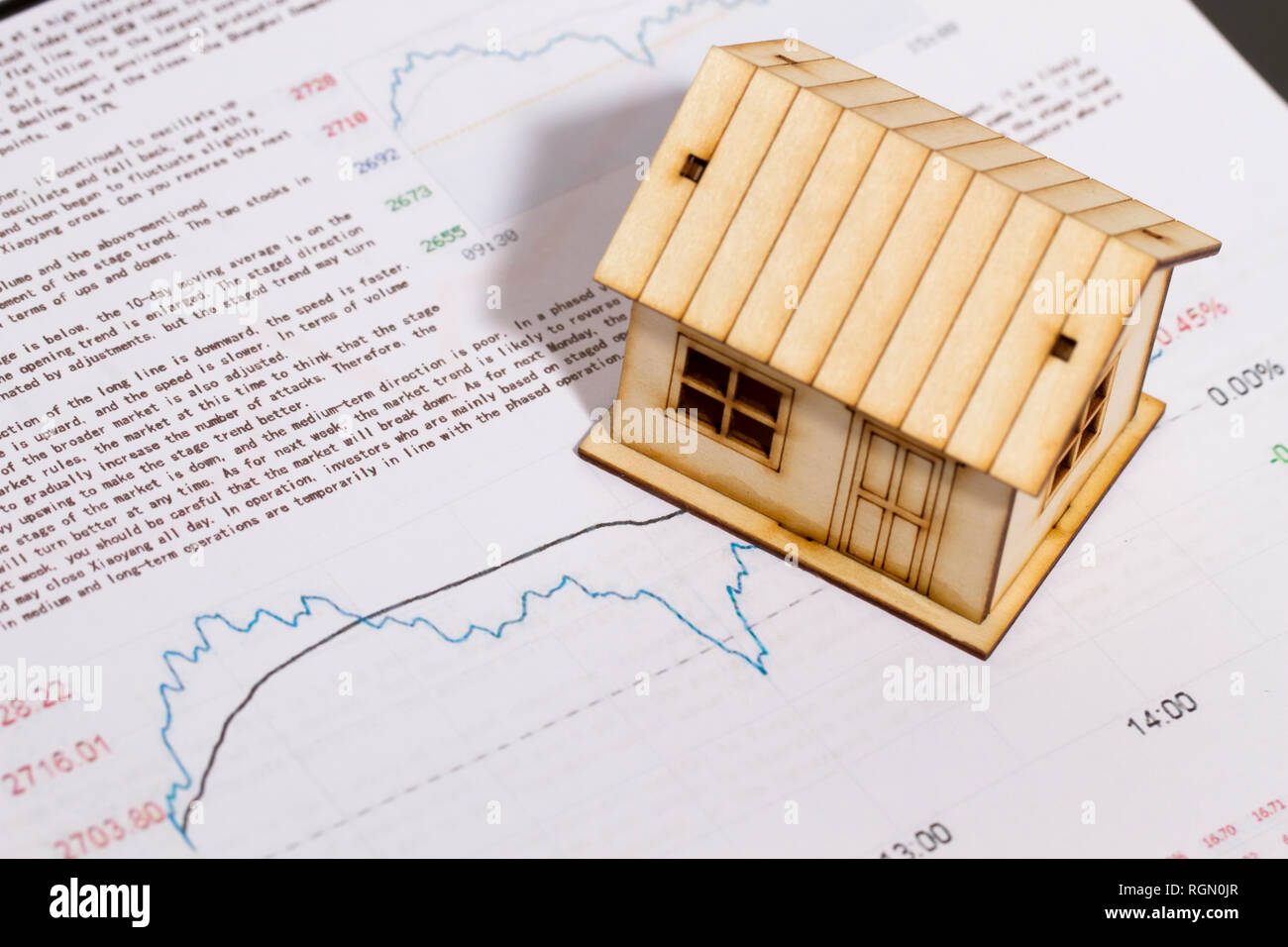 Small house with economic charts, real estate analysis Stock Photo Alamy
