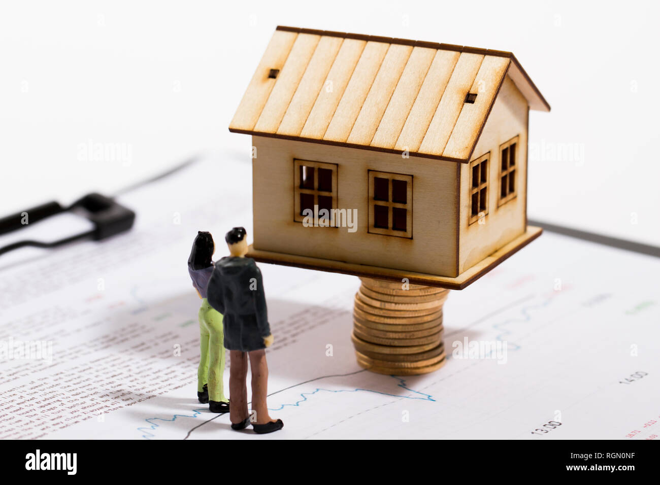 Small house with economic charts, real estate analysis Stock Photo Alamy