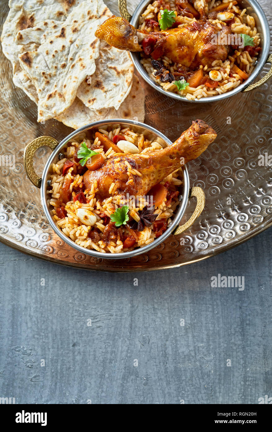 Bowls of spicy Arabian kabsa with meat and vegetables in long grain
