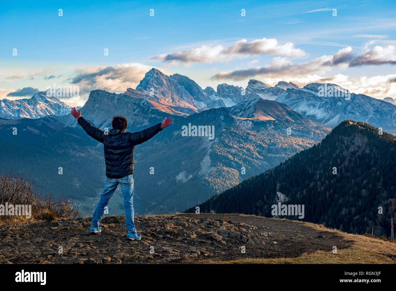 Italy, Trentino,Alpe di SIusi, , Hiker in front of Seceda and Sass Rigais at sunrise Stock Photo