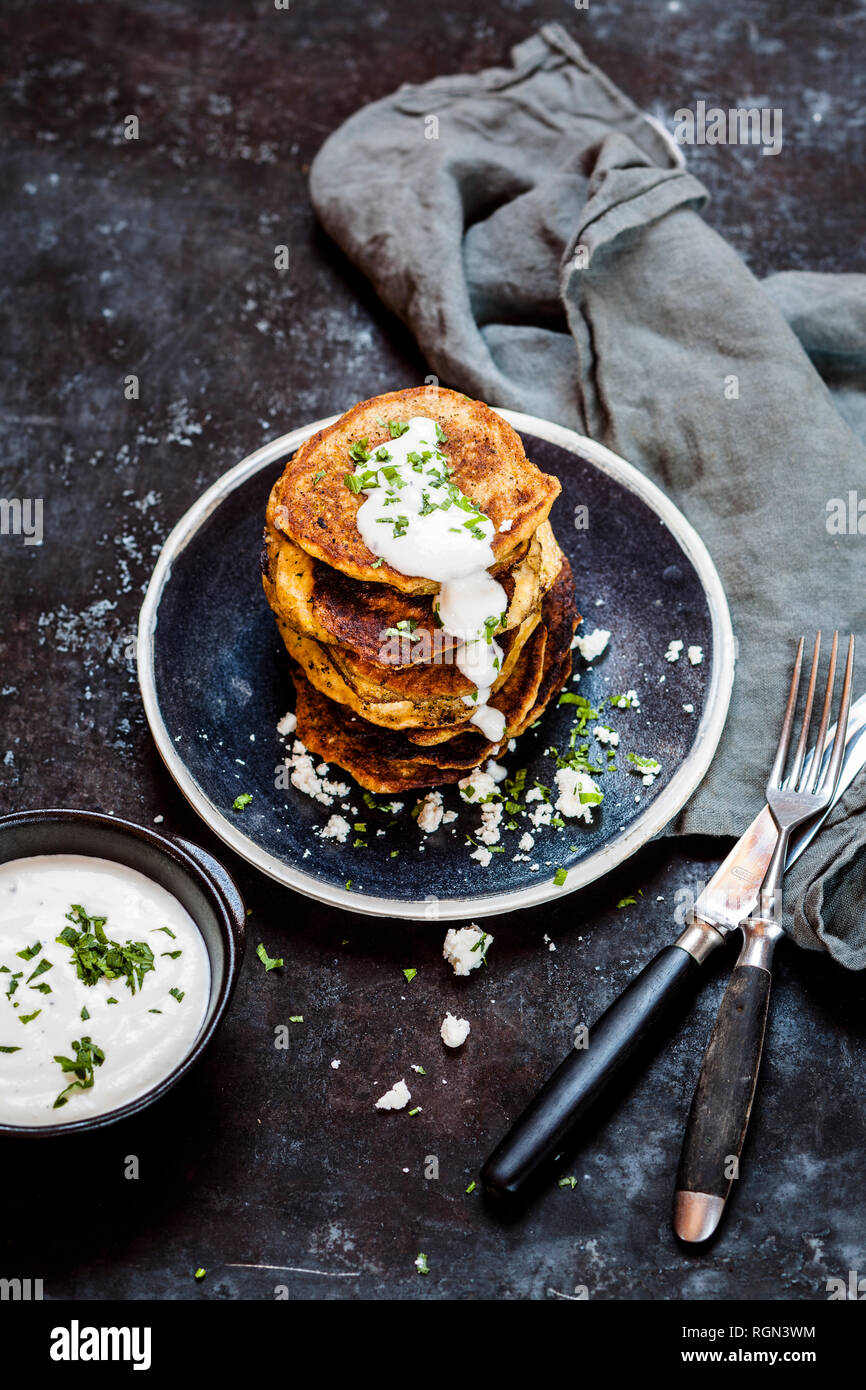Stack of zucchini fritters with garlic yogurt sauce and feta Stock Photo Alamy