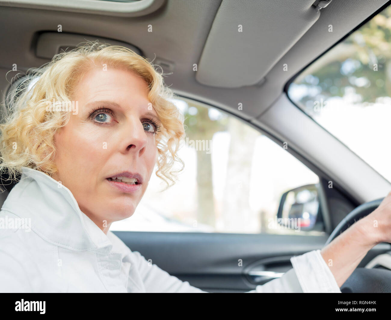 Portrait of mature woman driving car Stock Photo