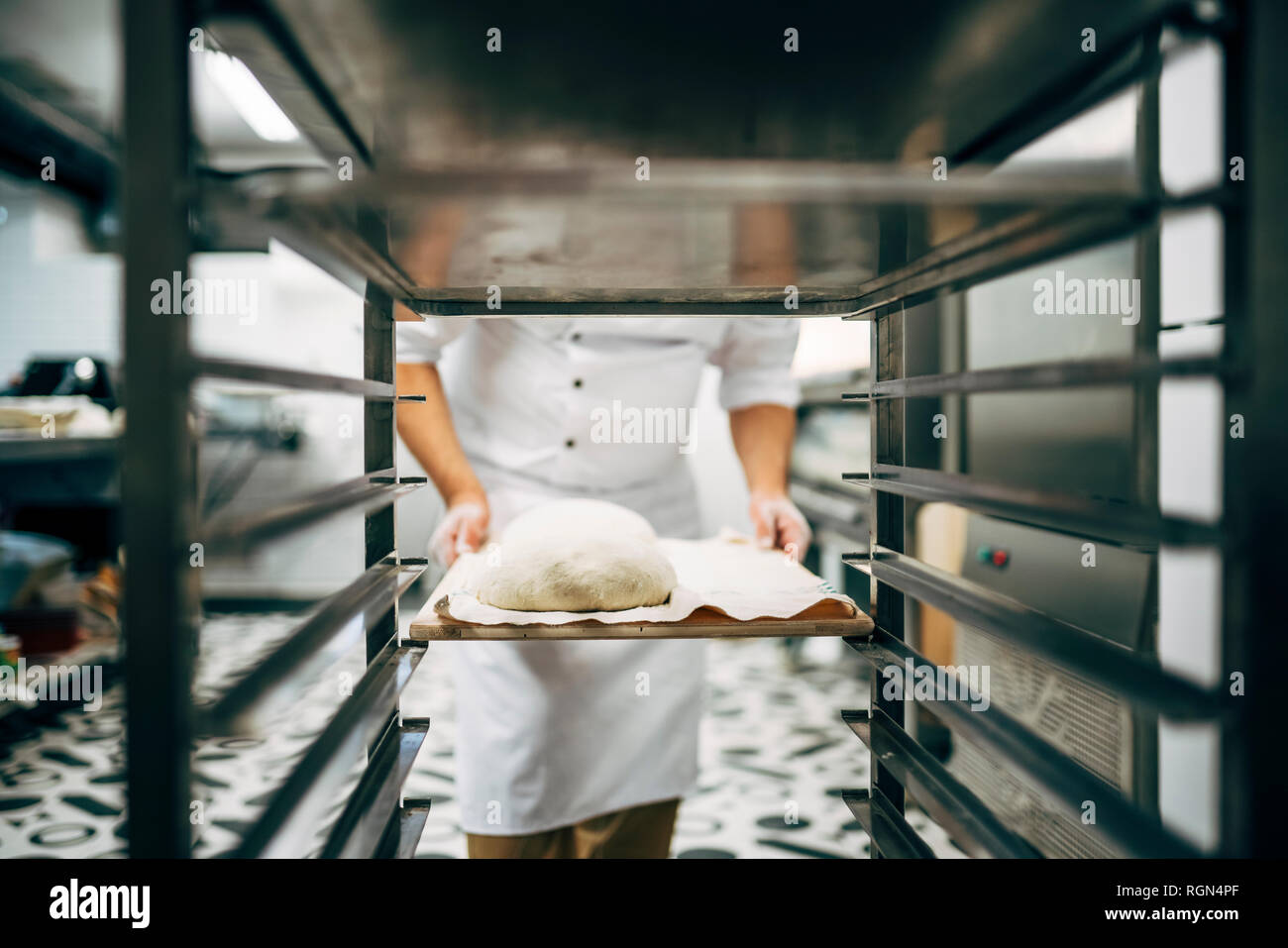 Baker working preparing tray to make bread Stock Photo