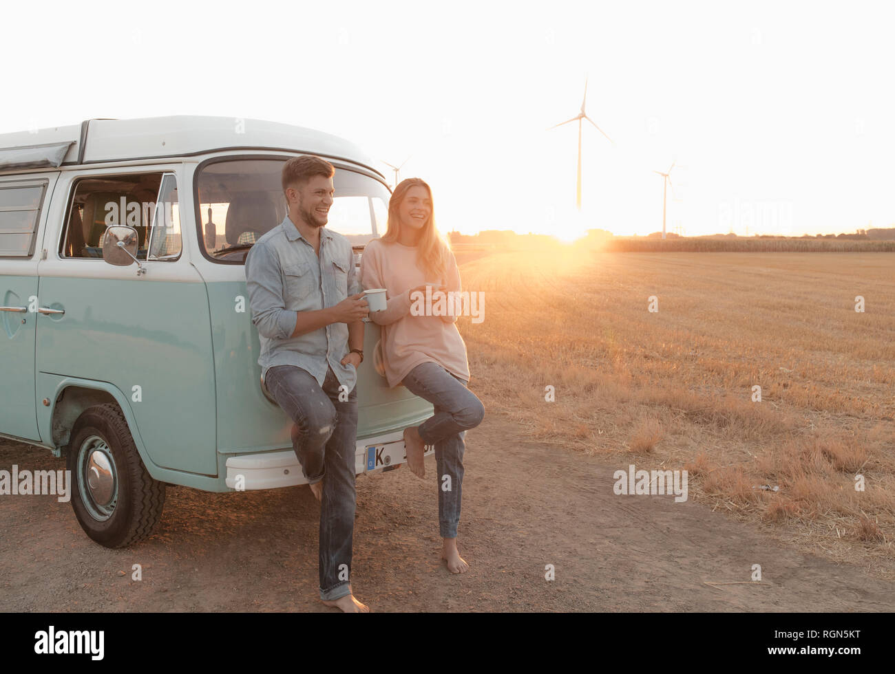 Happy young couple camper van rural landscape sunset hi-res stock ...