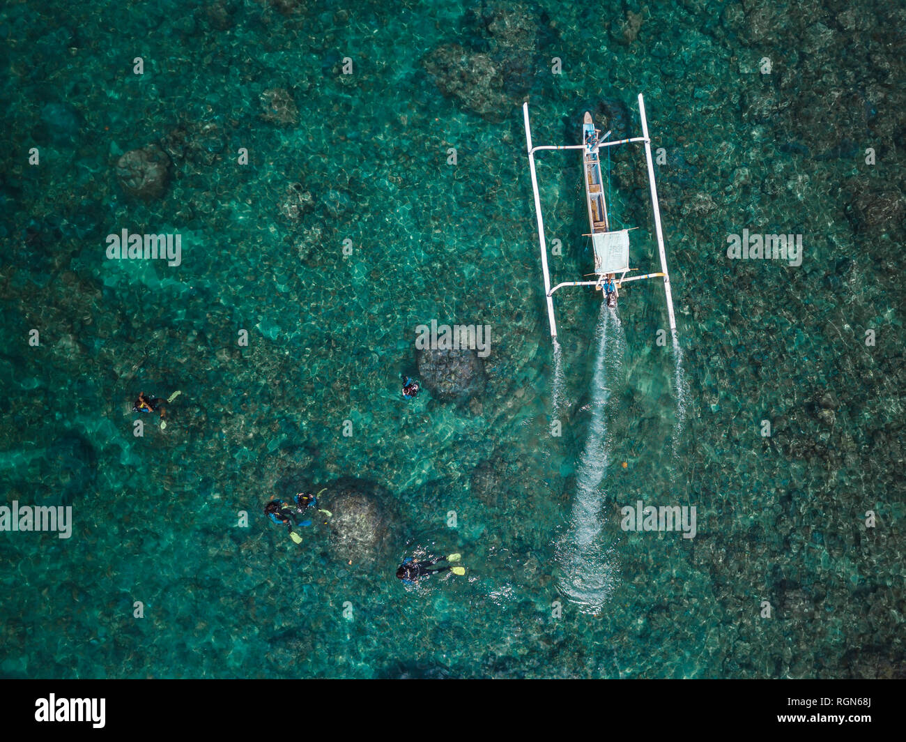 Indonesia, Bali, Divers and traditional boat Stock Photo