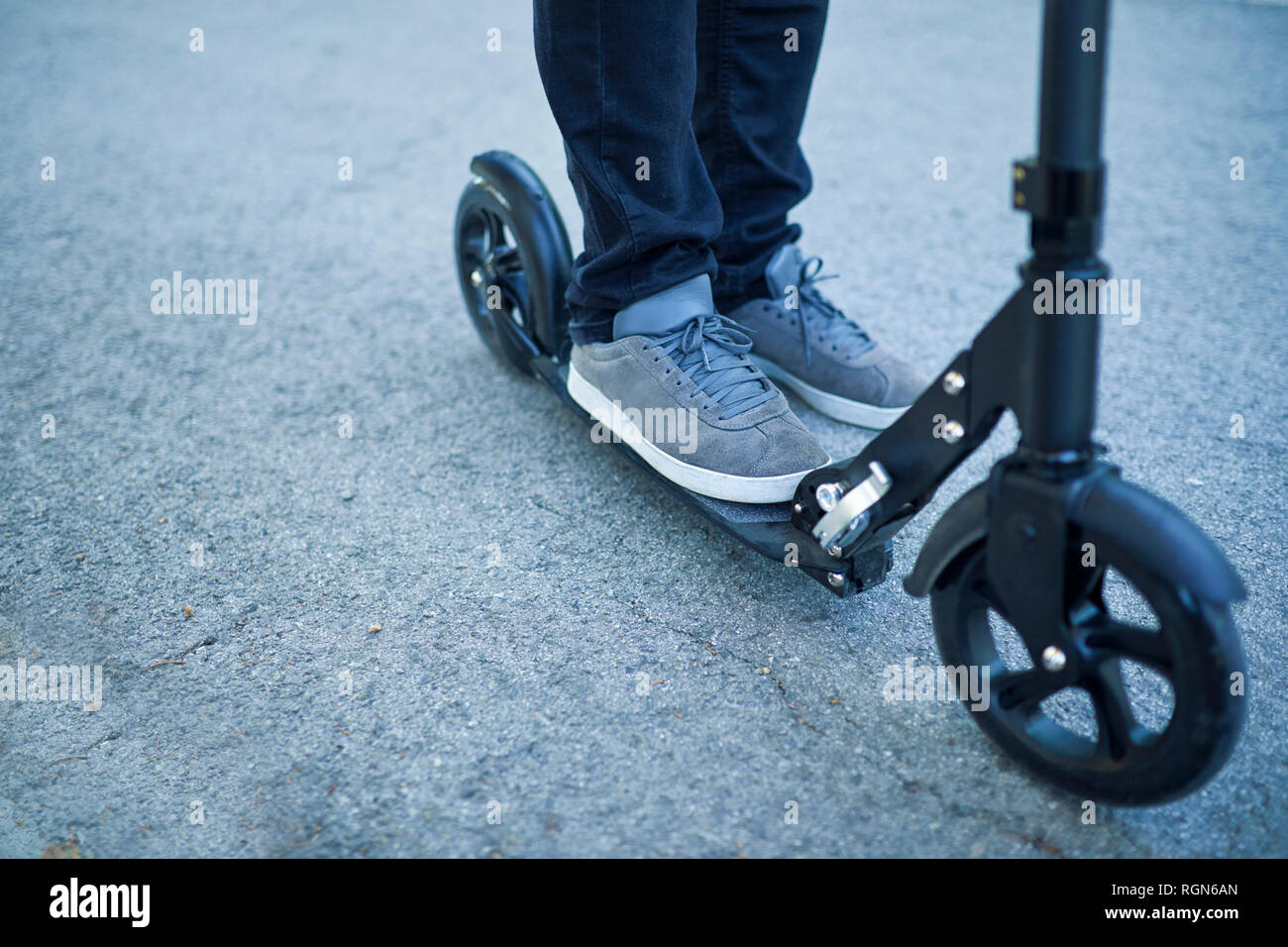 Man's feet on scooter Stock Photo