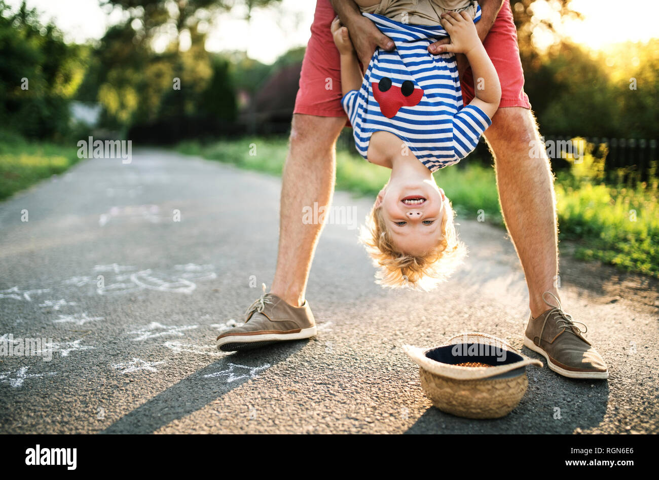 Portrait of laughing toddler having fun with his father outdoors Stock Photo