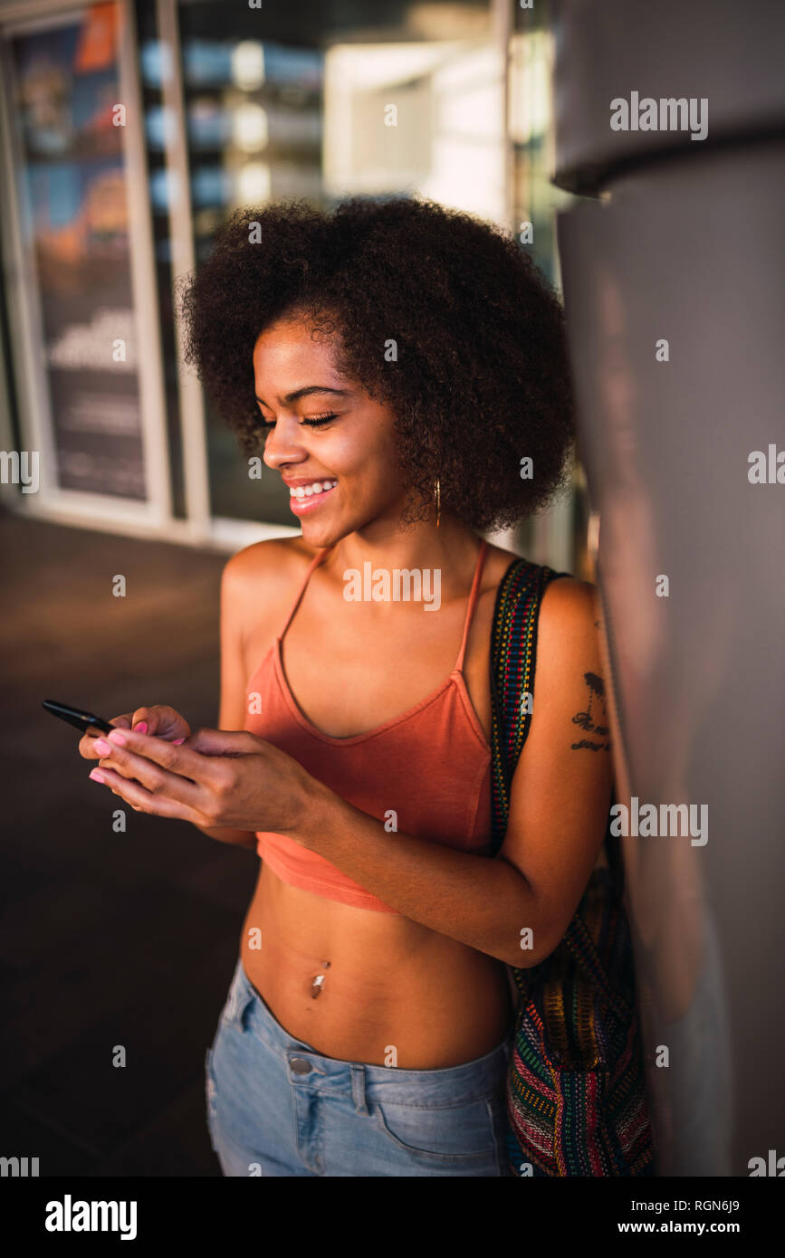 Happy young woman using cell phone Stock Photo