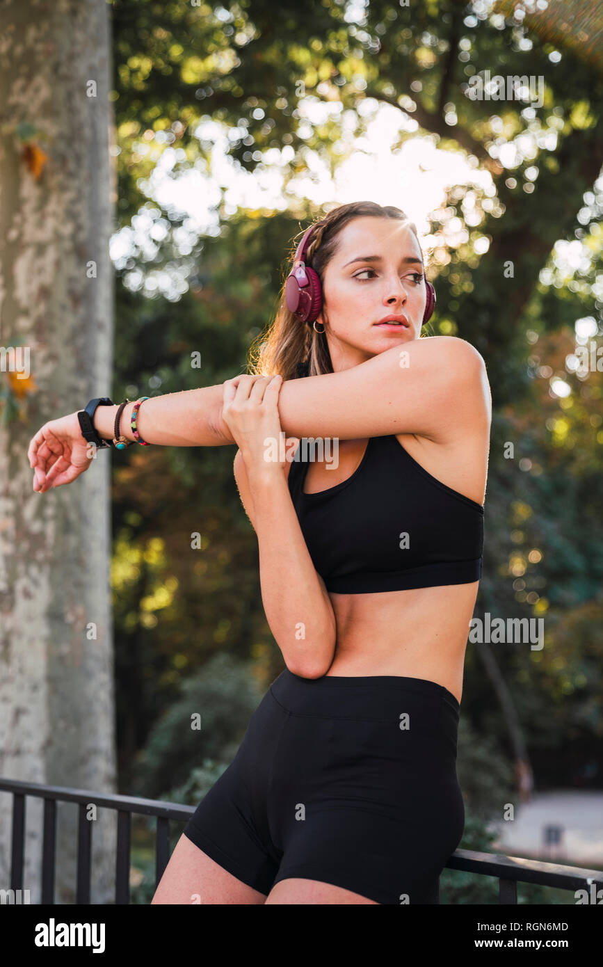 Fit young woman stretching before training Stock Photo
