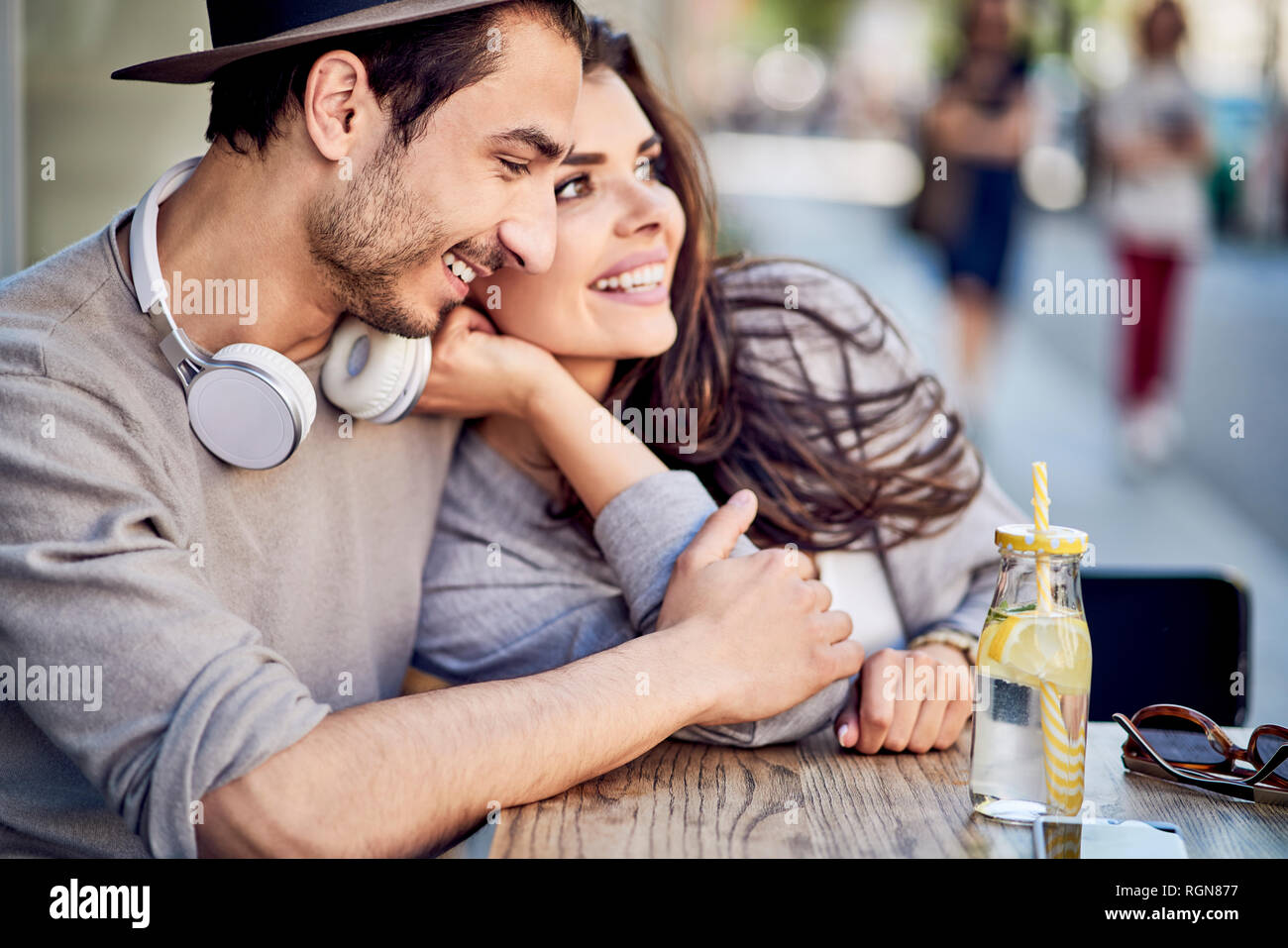 Happy affectionate young couple at outdoors cafe Stock Photo