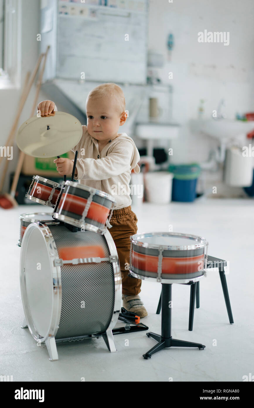 Toddler with toy drums Stock Photo
